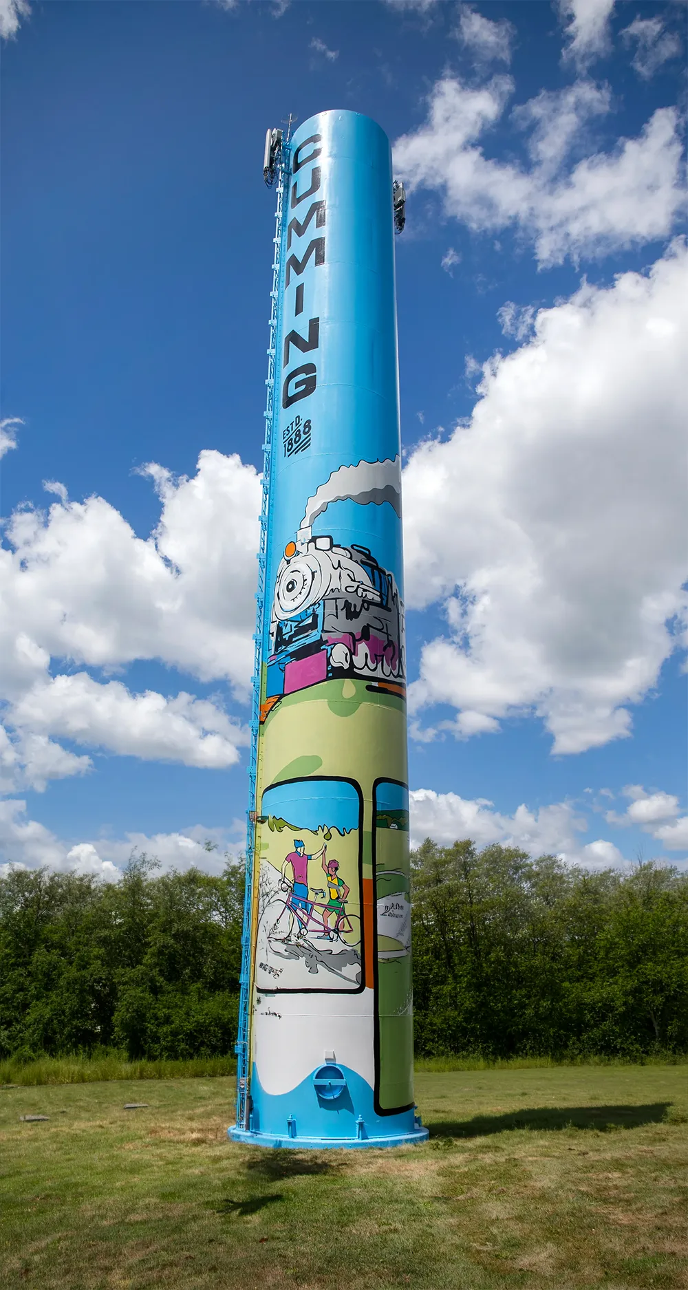 The painted Cumming water tower against a blue sky